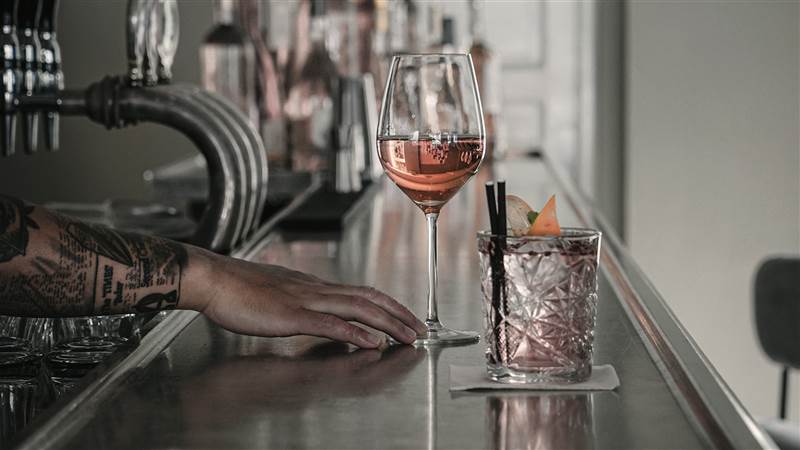 Wine Bar in Copenhagen - Tattooed Hand With Wine & Cocktail At Bar