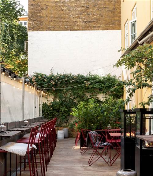 Urban Terrace Copenhagen - Courtyard Patio With Red Chairs & Lights