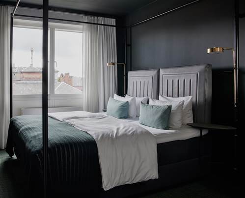 Modern Hotel Room in Copenhagen with Canopy Bed & City View