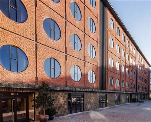Hotel Copenhagen City Centre - Red Brick Hotel Facade with Round Win